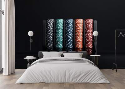 A set of poker chips in various colors (black, green, blue, orange, and red) neatly stacked in a black tray against a dark background. It胢s a minimalistic composition. Wall mural